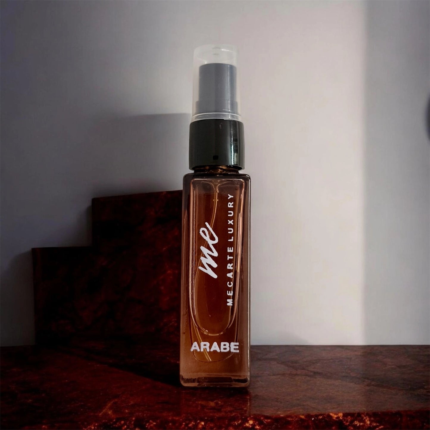Miniature perfume collection Arabe Mini 8ml bottle displayed against a textured background for luxury fragrance enthusiasts.