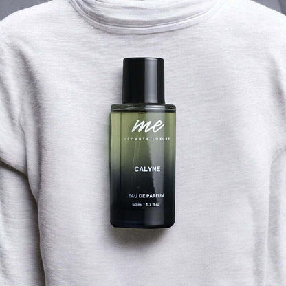 CALYNE, the best travel perfume India, displayed on a grey sweater, 50 ml Eau de Parfum bottle.