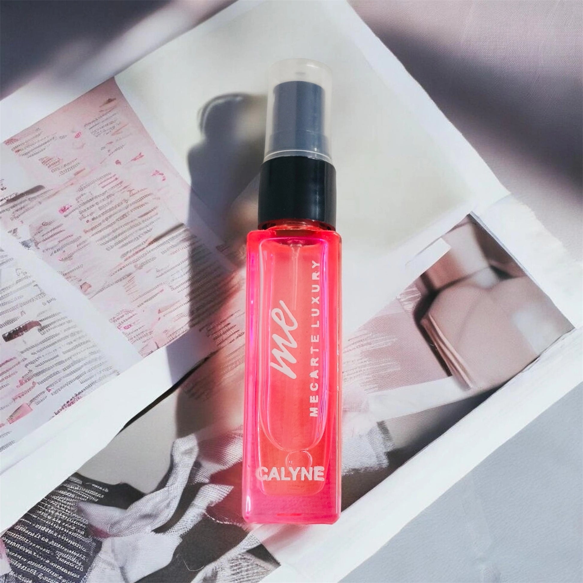 Travel size perfume Calyne Mini Perfume 8ml displayed on a stylish magazine background.
