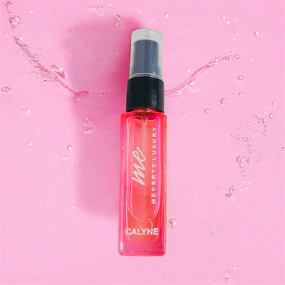 Travel size perfume Calyne Mini Perfume 8ml bottle on a pink background with water splashes.