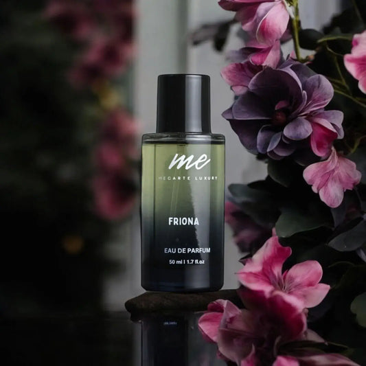 Long lasting ladies perfume Friona by Mecarte Luxury, 50 ml bottle surrounded by blooming flowers.